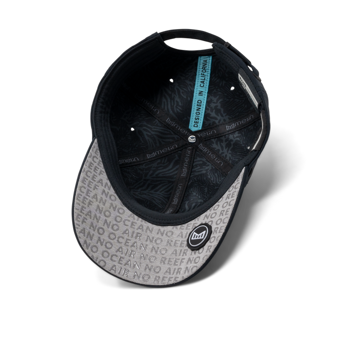 The inside view of the melin The Legend Coral Gardeners Hydro Performance Dad Hat in black