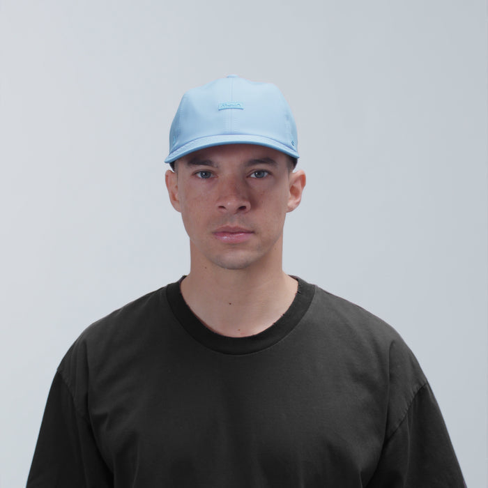 The model-image view of the melin Performance Dad Hat The Legend Hydro  in Cashmere Blue