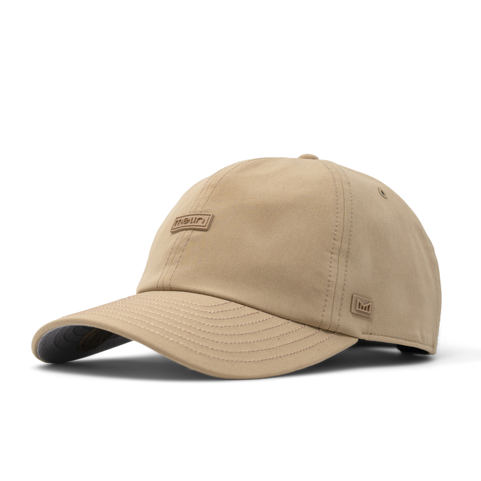 The angled view of the melin The Legend Hydro Performance Dad Hat in dark khaki