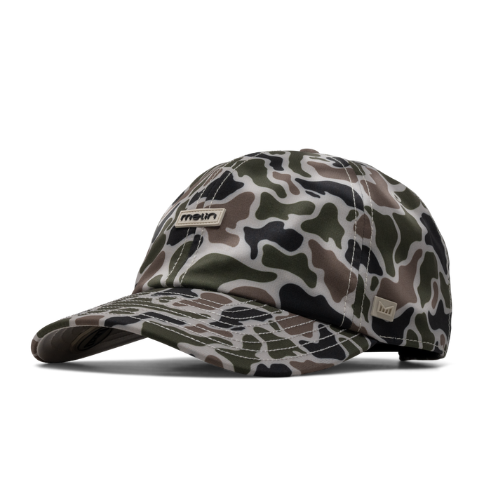The angled view of the melin The Legend Hydro Performance Dad Hat in duck camo