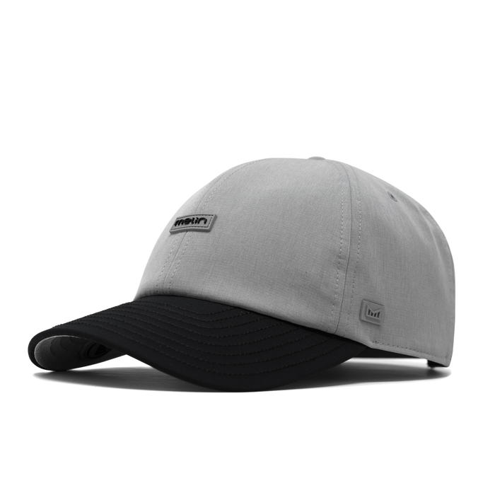 The front, angled view of the melin The Legend Hydro  Performance Dad Hat in Heather Grey / Black