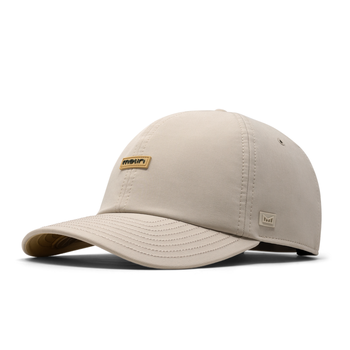 The front, angled view of the melin The Legend Hydro Performance Dad Hat in Sandshell