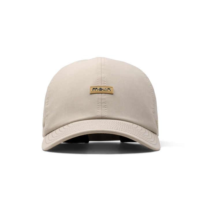 The front view of the melin The Legend Hydro Performance Dad Hat in Sandshell