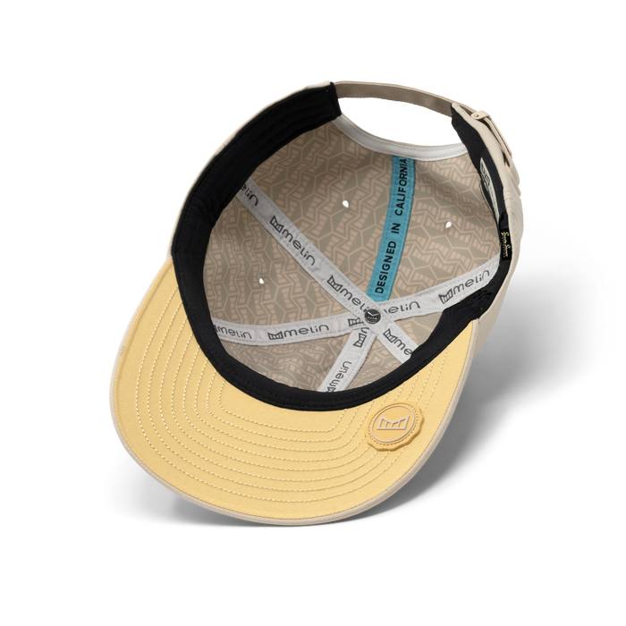 The inside view of the melin The Legend Hydro Performance Dad Hat in Sandshell