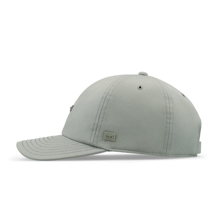 Sage green baseball cap with stitched panels and small metal brand logo on front.