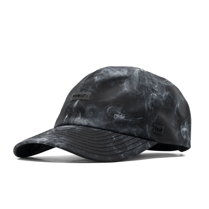 The angled view of the melin The Legend Hydro Performance Dad Hat in smoke