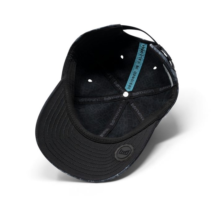 The inside view of the melin The Legend Hydro Performance Dad Hat in smoke