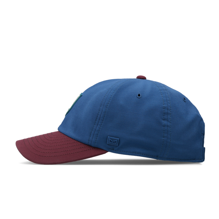 The side view of the melin Performance Dad Hat The Legend Links Clubhouse Hydro in grandeur