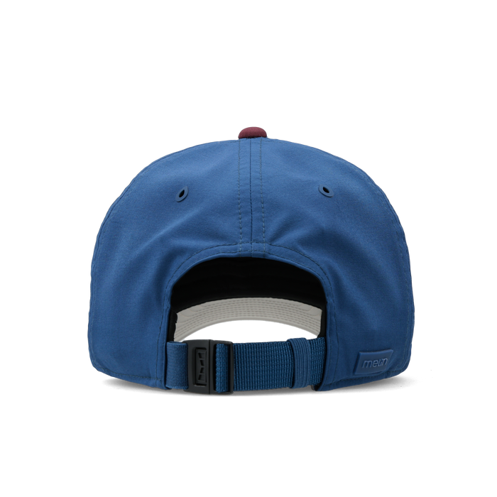 The back view of the melin Performance Dad Hat The Legend Links Clubhouse Hydro in grandeur