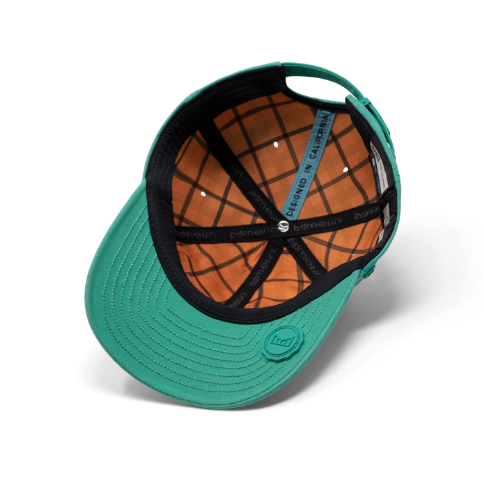 The inside view of the melin Performance Dad Hat The Legend Links Hydro  in  Neon Aqua