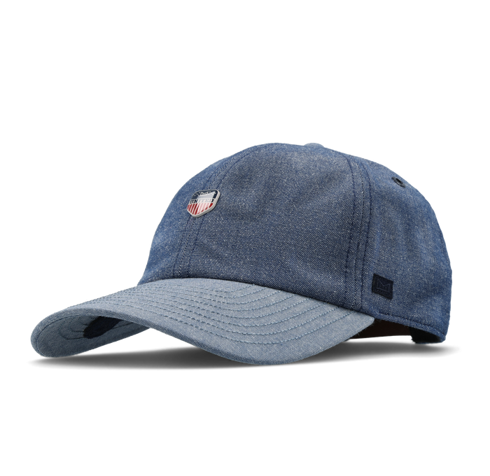 The angled view of the melin The Legend Mill United Performance Dad Hat in chambray