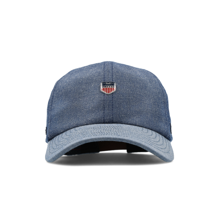The frontal view of the melin The Legend Mill United Performance Dad Hat in chambray