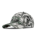 The angled view of the melin The Legend Mill Visions Performance Dad Hat in garden