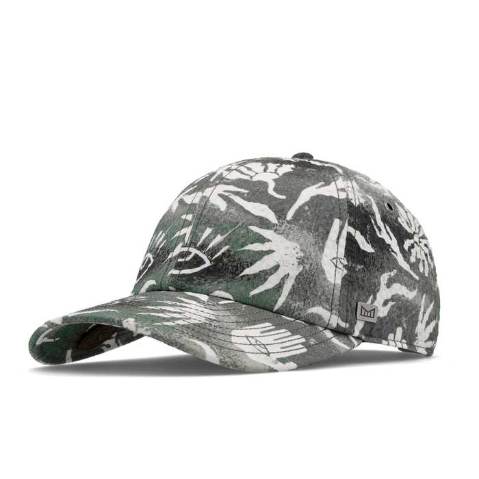 The angled view of the melin The Legend Mill Visions Performance Dad Hat in garden