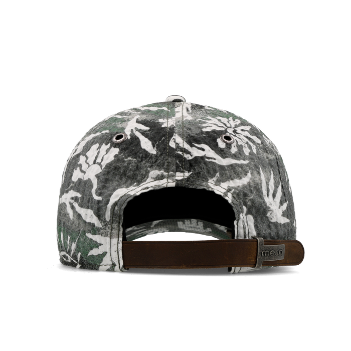 The back view of the melin The Legend Mill Visions Performance Dad Hat in garden