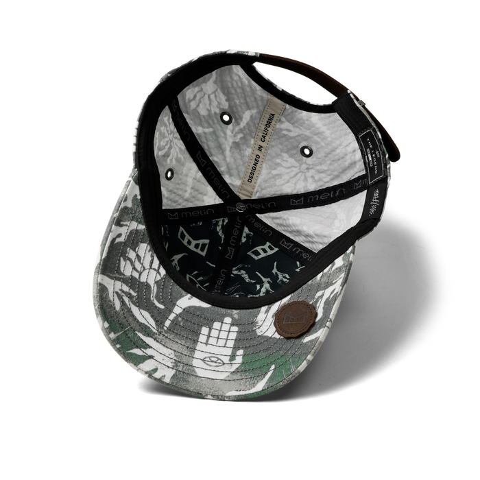 The inside view of the melin The Legend Mill Visions Performance Dad Hat in garden