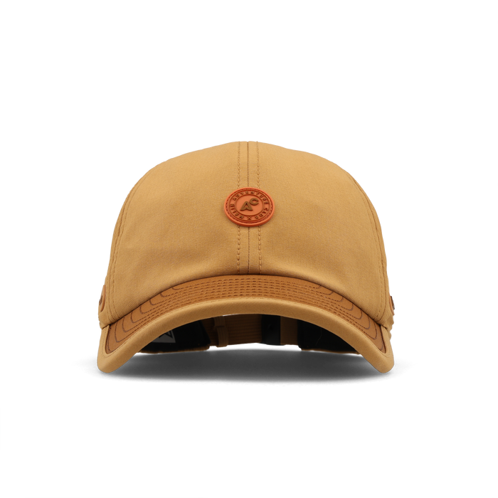 The front view of the melin The Legend Packable Hydro Performance Dad Hat in Bone Brown