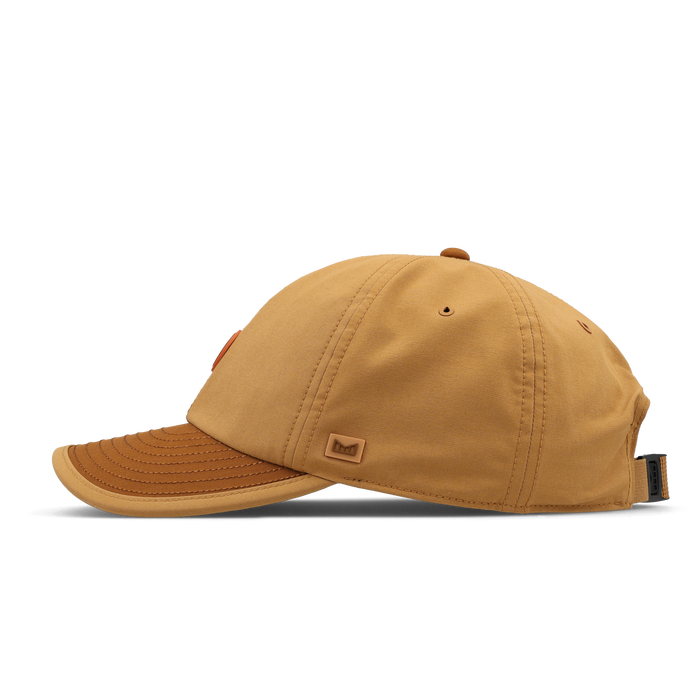 The side view of the melin The Legend Packable Hydro Performance Dad Hat in Bone Brown
