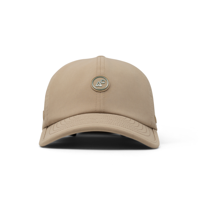 The front view of the melin The Legend Packable Hydro  Performance Dad Hat in  Sand
