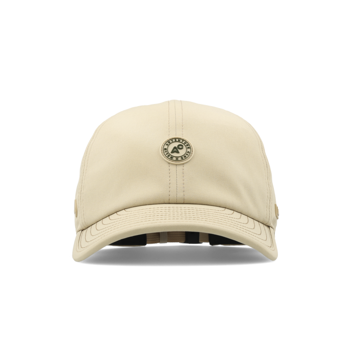 The frontal view of the melin The Legend Packable Hydro Performance Dad Hat in sand