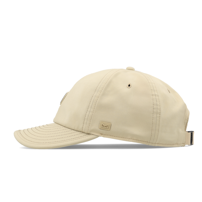 The side view of the melin The Legend Packable Hydro Performance Dad Hat in sand