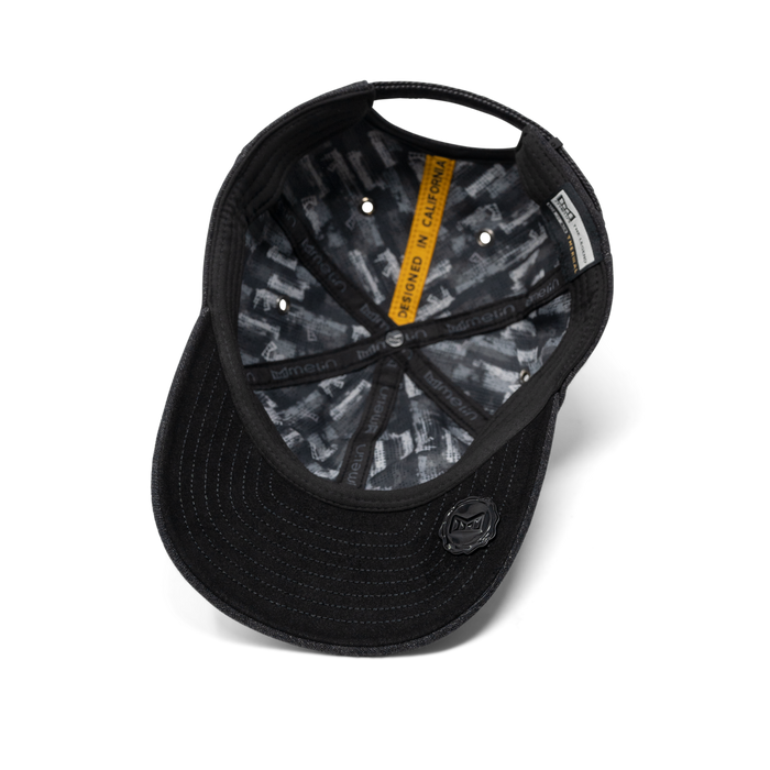 The inside view of the melin The Legend Thermal  Performance Dad Hat in Black Denim
