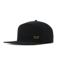 Black snapback cap with perforated side panels and small gold logo badge on front.