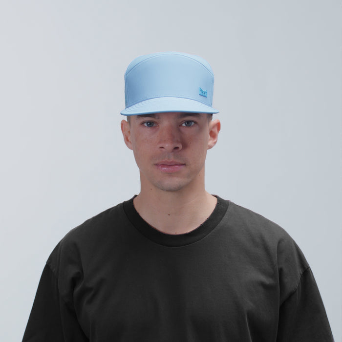 The model-image view of the melin Horizon Fit Trenches Icon Hydro hat in Cashmere Blue