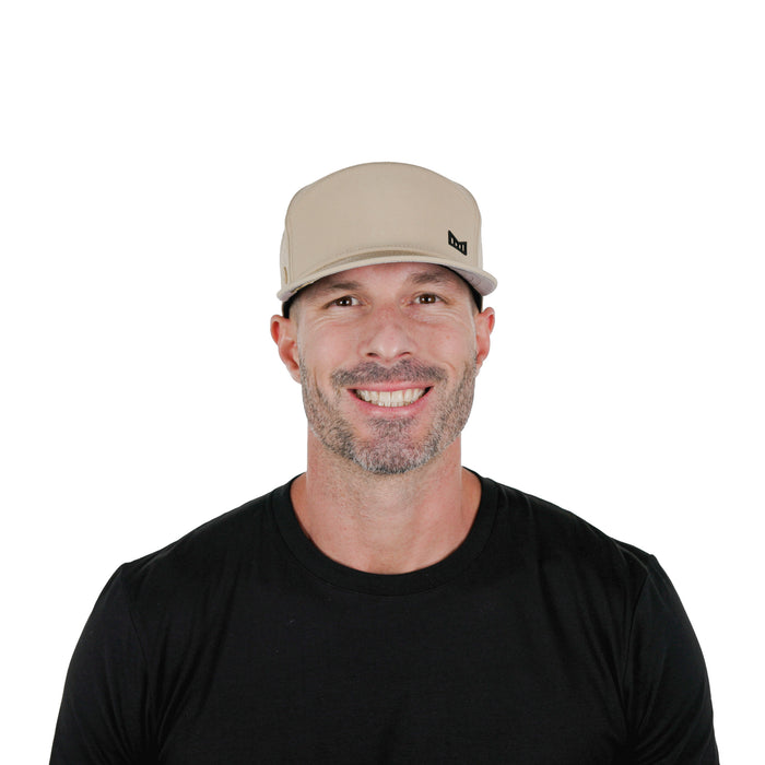 The model-image of the Melin Horizon Fit Trenches Icon Hydro hat in Khaki