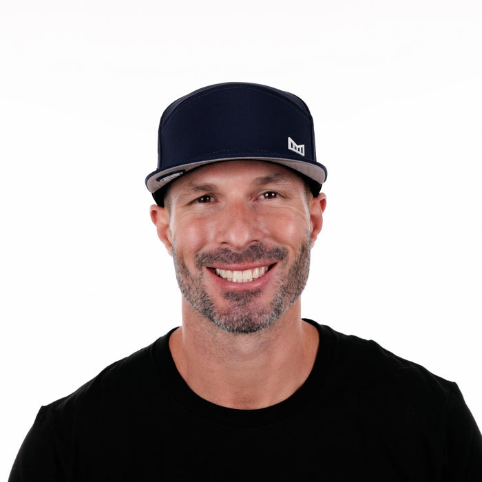 The model-image of the Melin Horizon Fit Trenches Icon Hydro hat in Navy