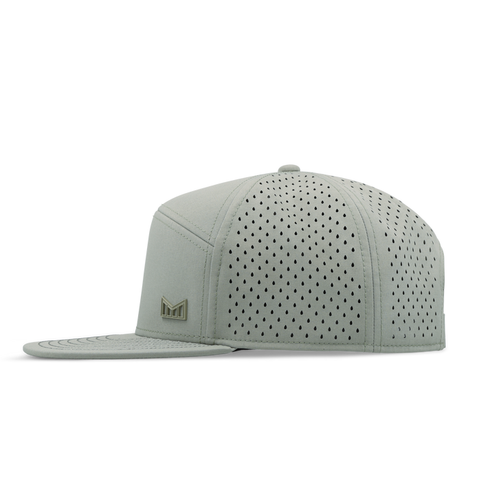 Sage green snapback cap with perforated vents on crown and back panel, small logo on side.