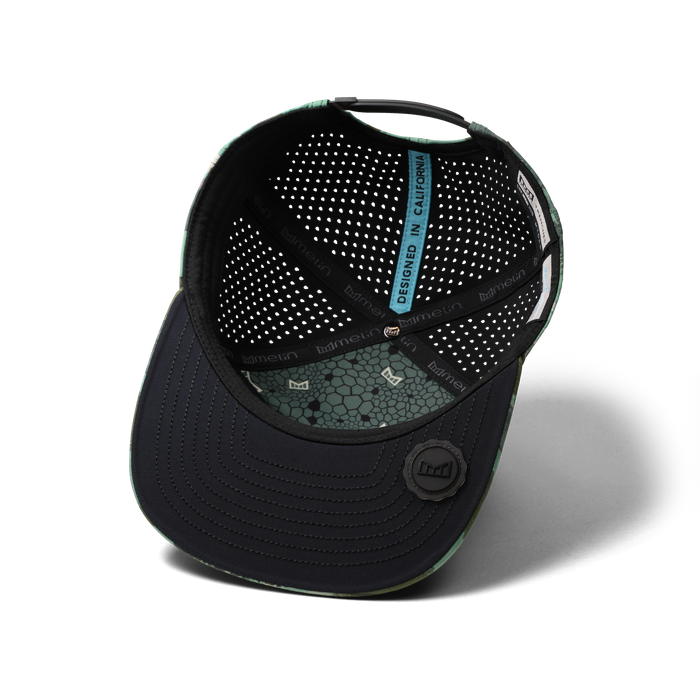 The inside view of the melin Horizon Fit Trenches Icon Hydro hat in watercolor camo