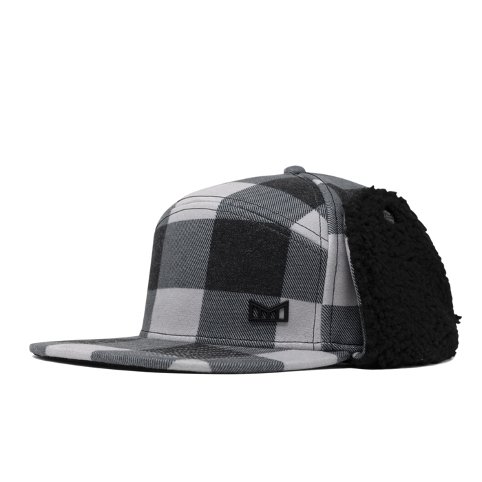 Black and white plaid snapback cap with black fuzzy ear flaps on the side.