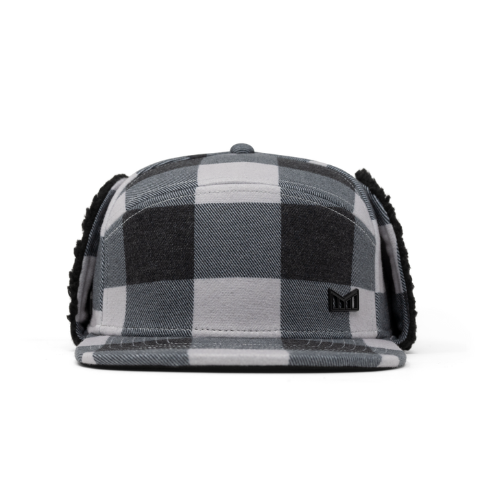 Black and white buffalo plaid thermal cap with ear flaps and small logo patch on front.