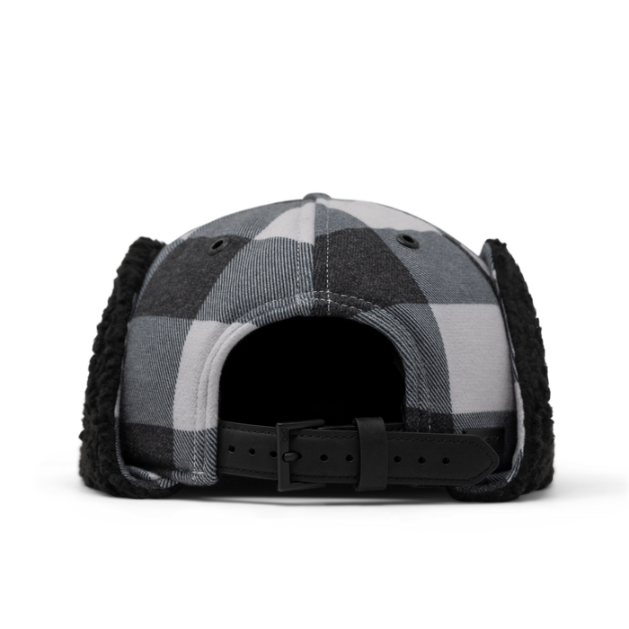 Black and white buffalo plaid baseball cap with black thermal ear flaps and adjustable back strap.