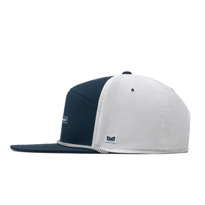The side view of the melin Trenches Links Drive Hydro  Horizon Fit in  Navy / White
