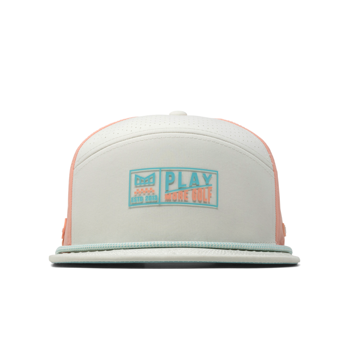 The front view of the melin Trenches Links Hydro  Horizon Fit in  Peach Nectar