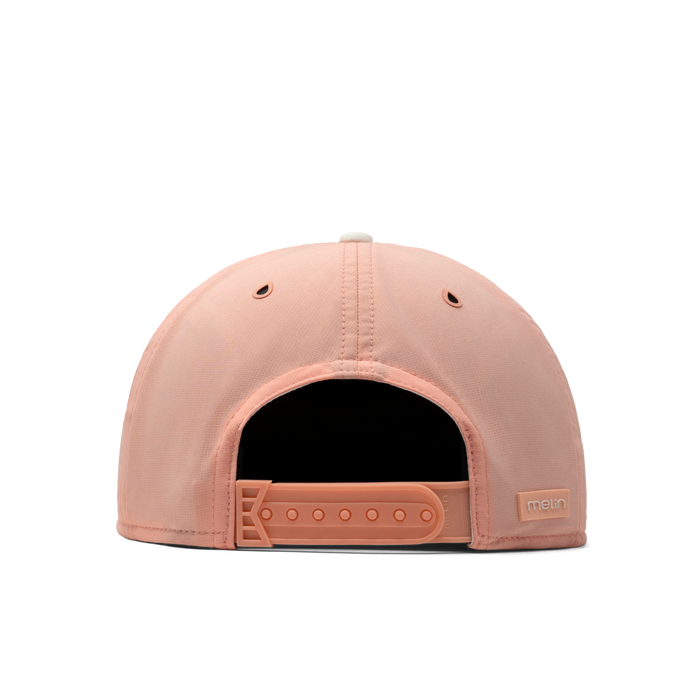 The back view of the melin Trenches Links Hydro  Horizon Fit in  Peach Nectar
